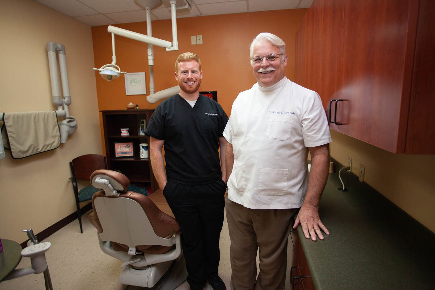 IN THEIR BLOOD: Dr. Robert Reynolds, right, is the third generation to manage Ozarks Preferred Dental Group since 1919. Dr. George Vincel — Reynolds’ godson — joined the practice last year.